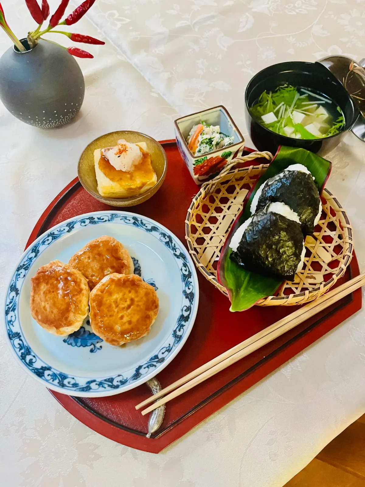 Tofu Course: tofu hamburger steak, agedashi tofu, onigiri and clear soup on a red tray